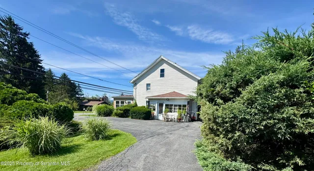 a front view of a house with a yard and porch