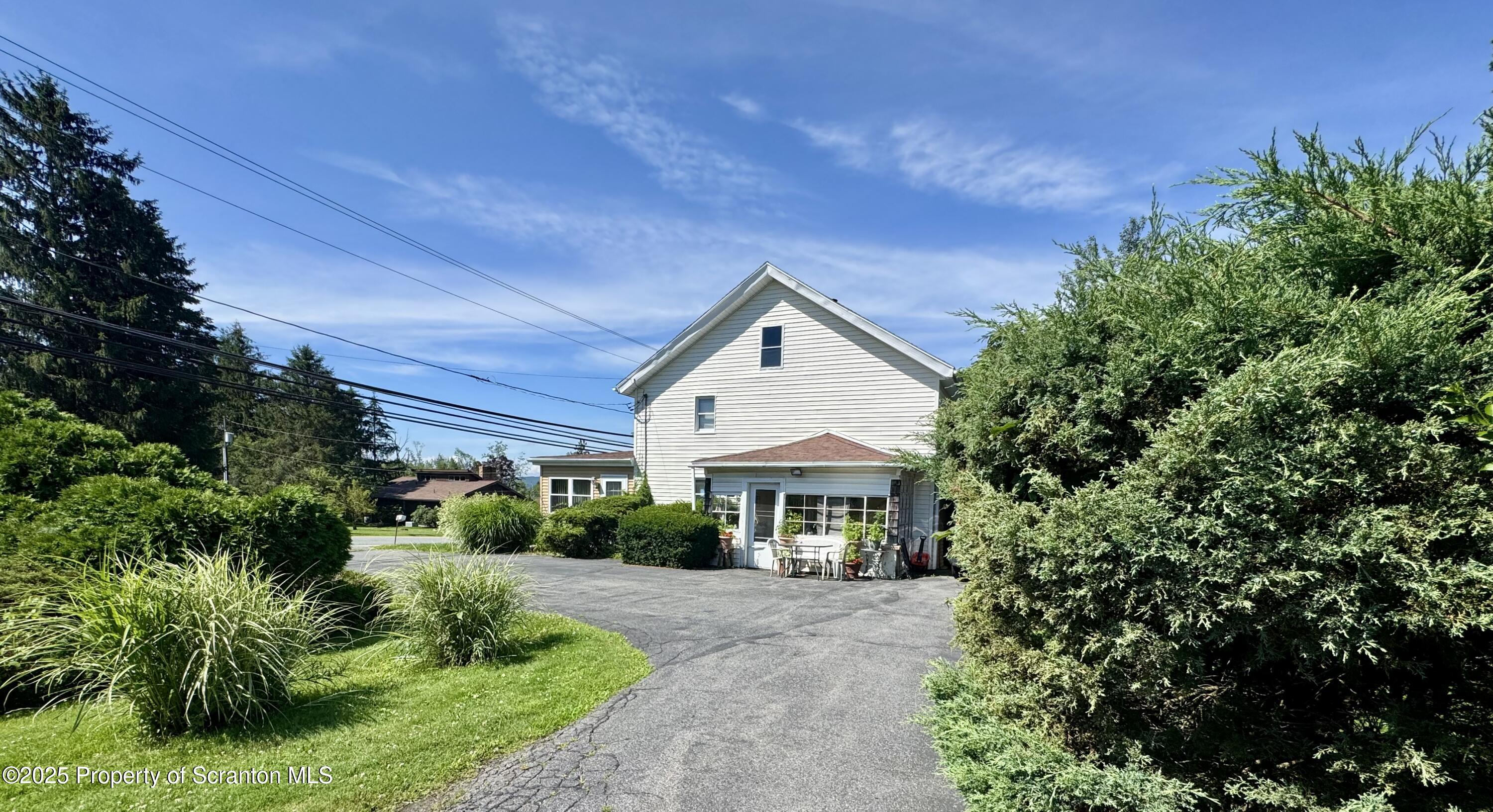 1325 Fairview Road Clarks Summit, PA 18411 - Photo 2 of 21 a front view of a house with a yard and porch