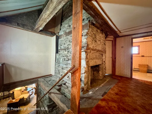 a view of a livingroom with wooden floor and stairs