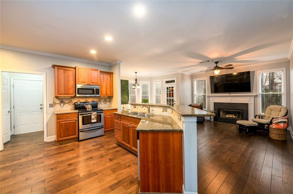 284 Graymist Path Southwest Loganville, GA 30052 - Photo 15 of 45 a kitchen with sink refrigerator and stove top oven