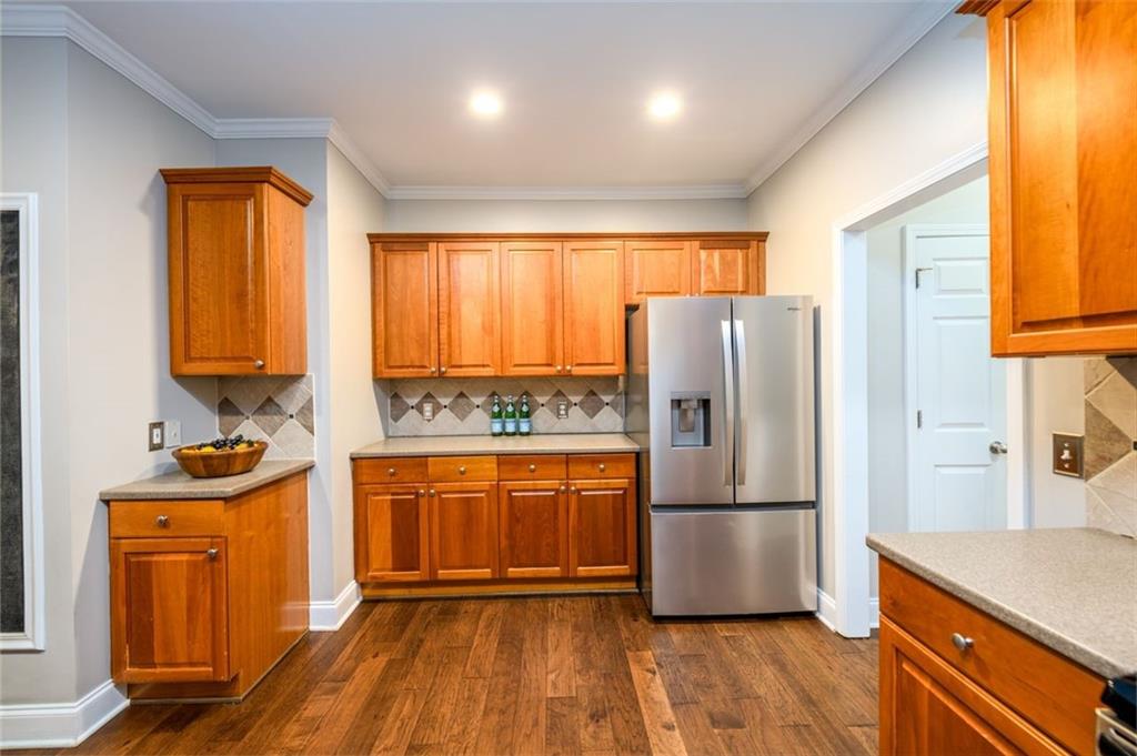 284 Graymist Path Southwest Loganville, GA 30052 - Photo 16 of 45 a kitchen with stainless steel appliances a refrigerator stove and sink