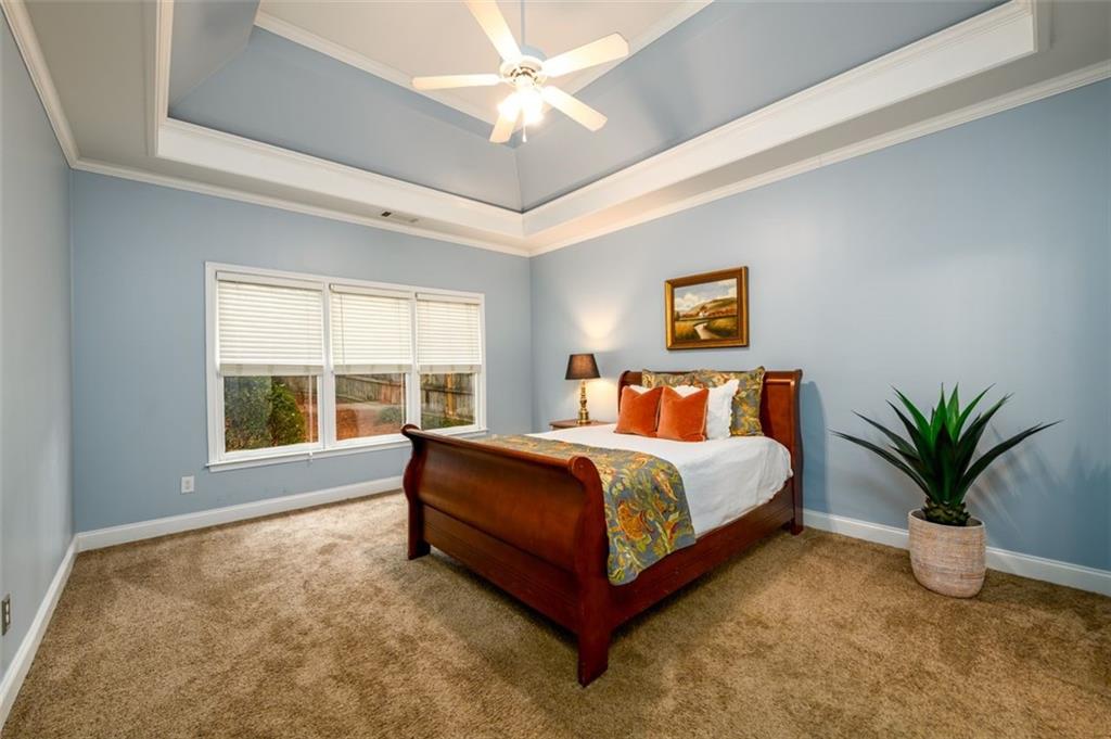284 Graymist Path Southwest Loganville, GA 30052 - Photo 23 of 45 a spacious bedroom with a large bed and a large window