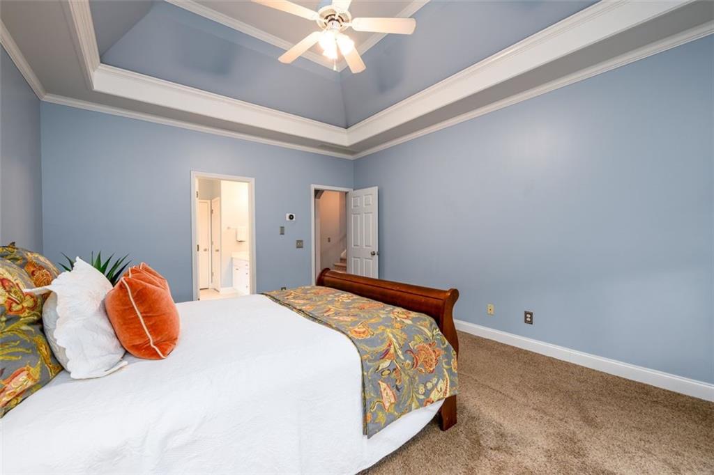 284 Graymist Path Southwest Loganville, GA 30052 - Photo 24 of 45 a bedroom with a bed and a chandelier