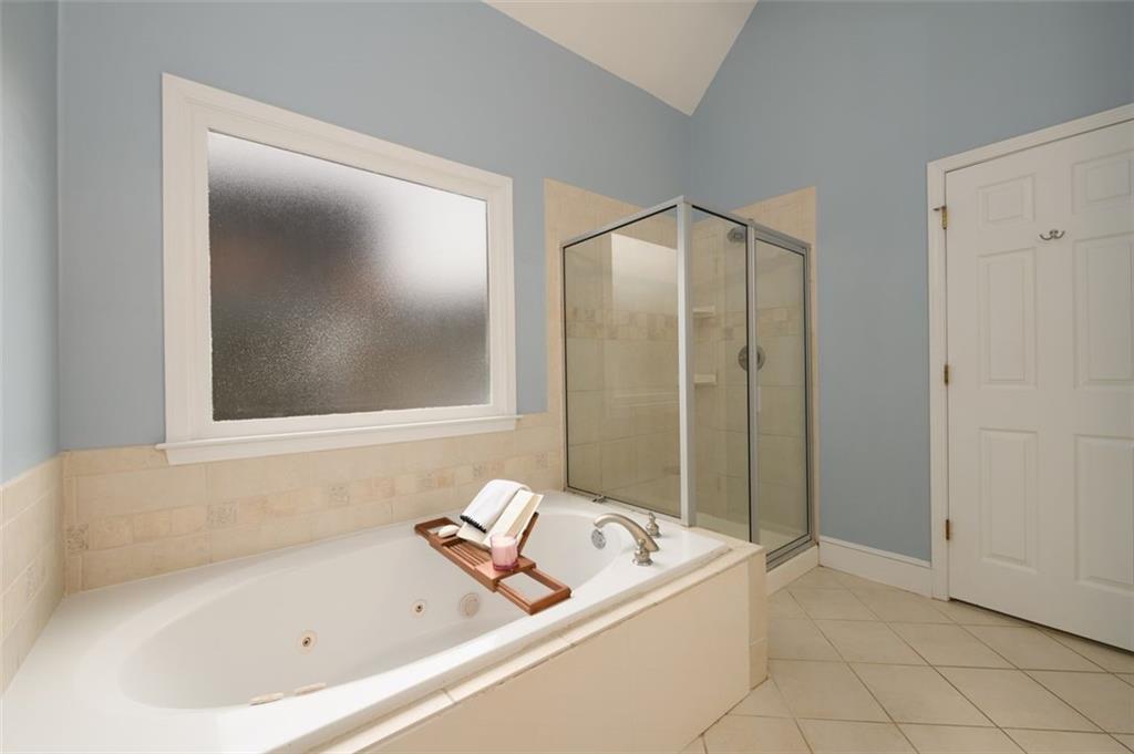 284 Graymist Path Southwest Loganville, GA 30052 - Photo 26 of 45 a bathroom with a bathtub and shower