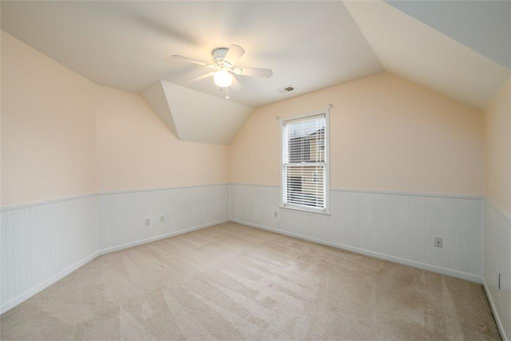 284 Graymist Path Southwest Loganville, GA 30052 - Photo 31 of 45 an empty room with a window and chandelier fan