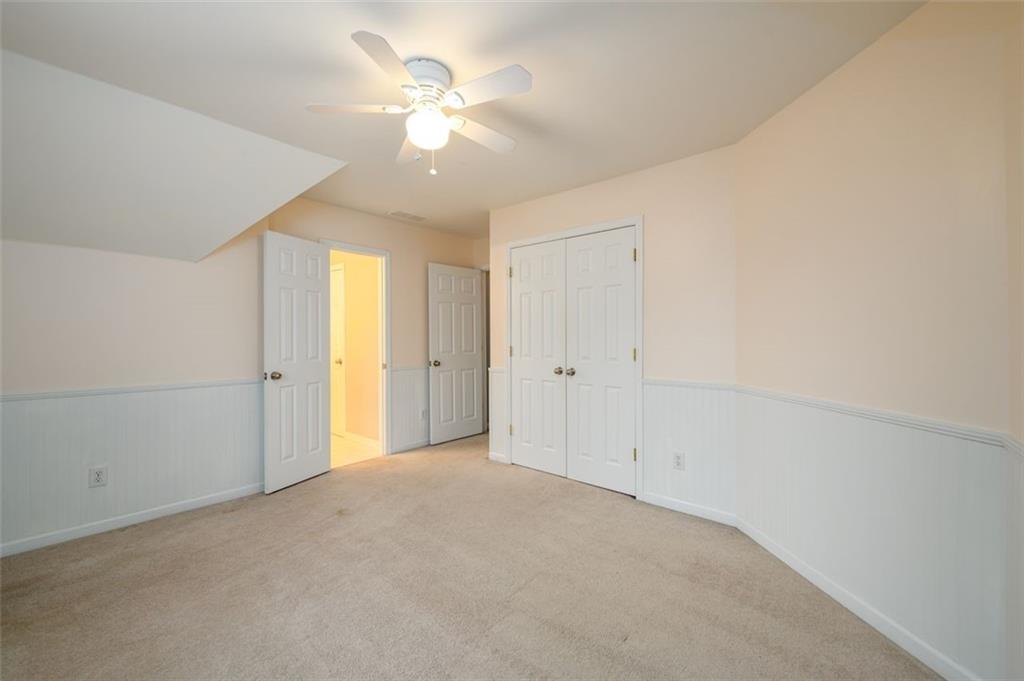 284 Graymist Path Southwest Loganville, GA 30052 - Photo 32 of 45 an empty room with a ceiling fan and a window