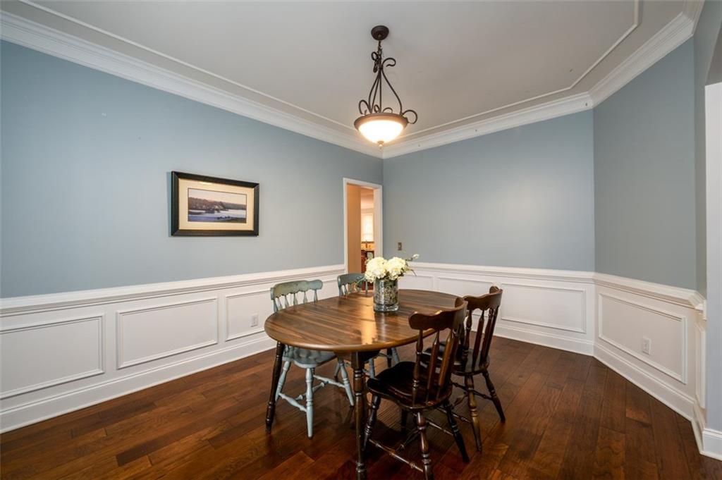284 Graymist Path Southwest Loganville, GA 30052 - Photo 7 of 45 a view of a dining room with furniture wooden floor and a chandelier