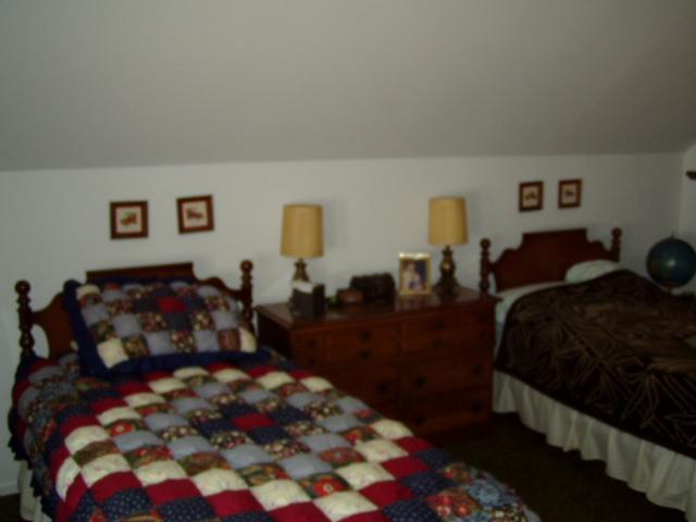 17 Winona Road Mount Pocono, PA 18344 - Photo 3 of 10 a bed room with a bed a couch and a window