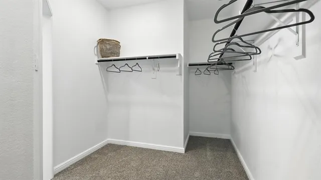 a bathroom with a granite countertop sink a mirror and a shower