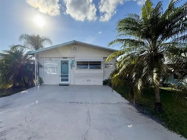 a view of a house with a yard and garage
