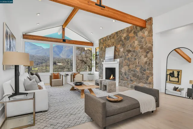 a living room with furniture a chandelier and a window