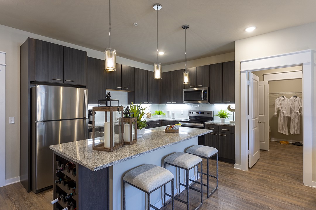 1724 Partnership Way, Unit 1263 Katy, TX 77449 - Photo 4 of 26 a kitchen with refrigerator a refrigerator and chairs