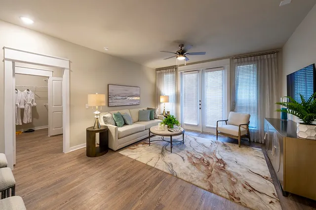 a living room with furniture and a large window