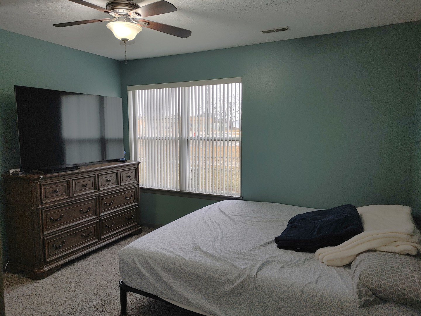 150 North Wooster Street, Unit 9 Capron, IL 61012 - Photo 14 of 23 a bedroom with a bed and a flat screen tv