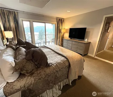 a bedroom with a bed and a television