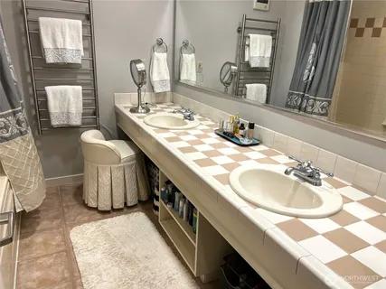 a bathroom with a sink double vanity and a mirror