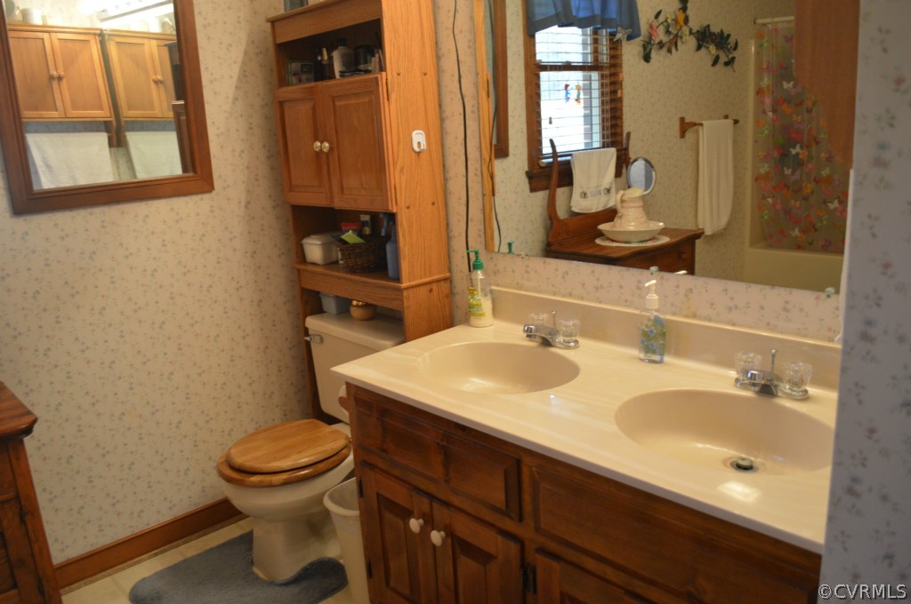 1820 Mill Road Henrico, VA 23231 - Photo 12 of 24 a bathroom with a sink a toilet and shower