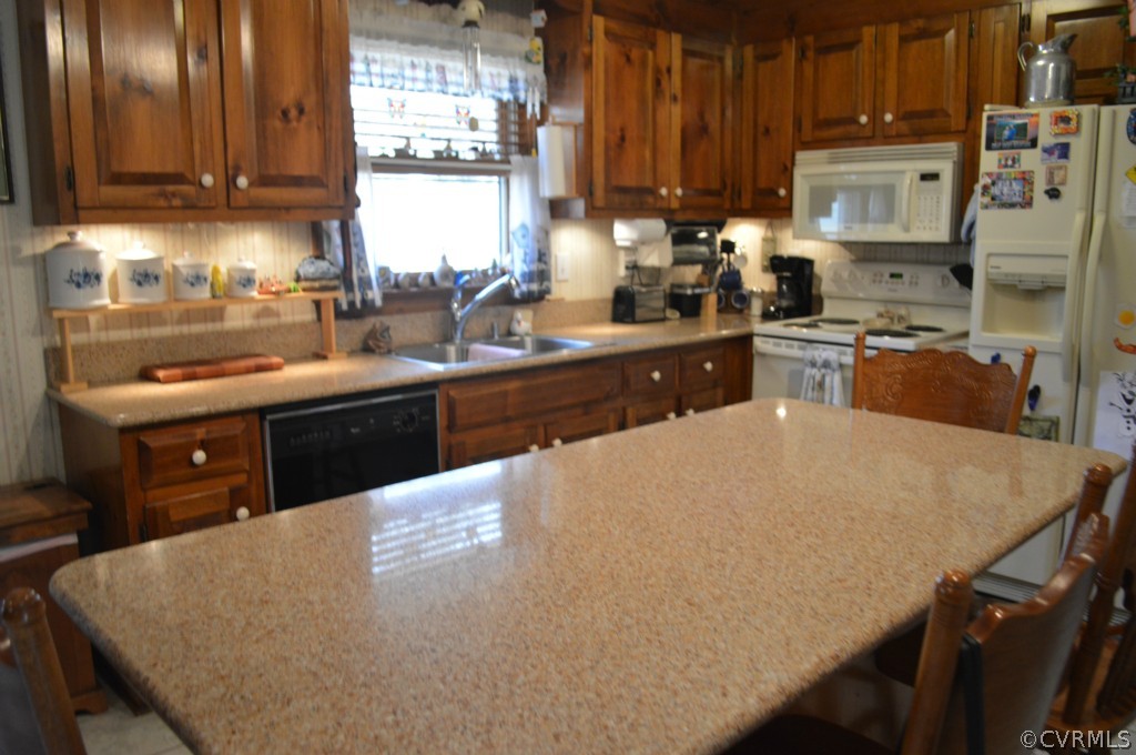 1820 Mill Road Henrico, VA 23231 - Photo 8 of 24 a kitchen with stainless steel appliances granite countertop a sink a stove and a refrigerator