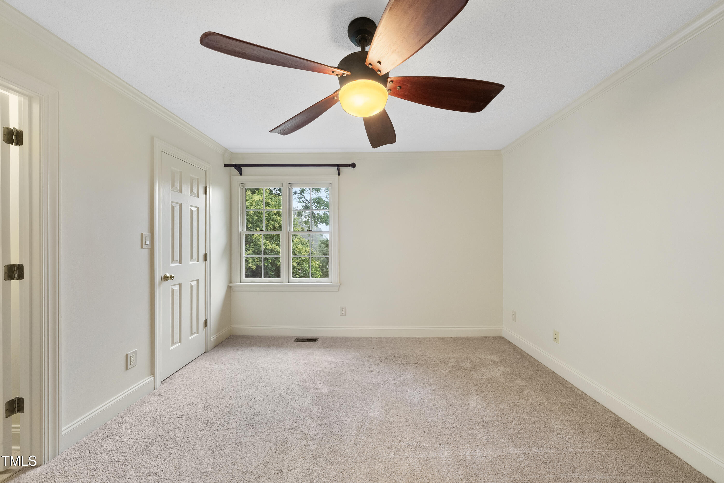 1403 Governors Court Raleigh, NC 27604 - Photo 17 of 34 an empty room with a window and a fan