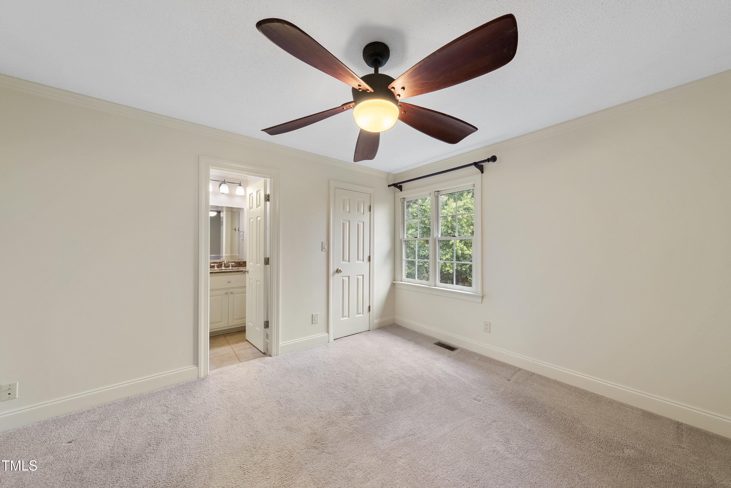 1403 Governors Court Raleigh, NC 27604 - Photo 18 of 34 an empty room with ceiling fan and window