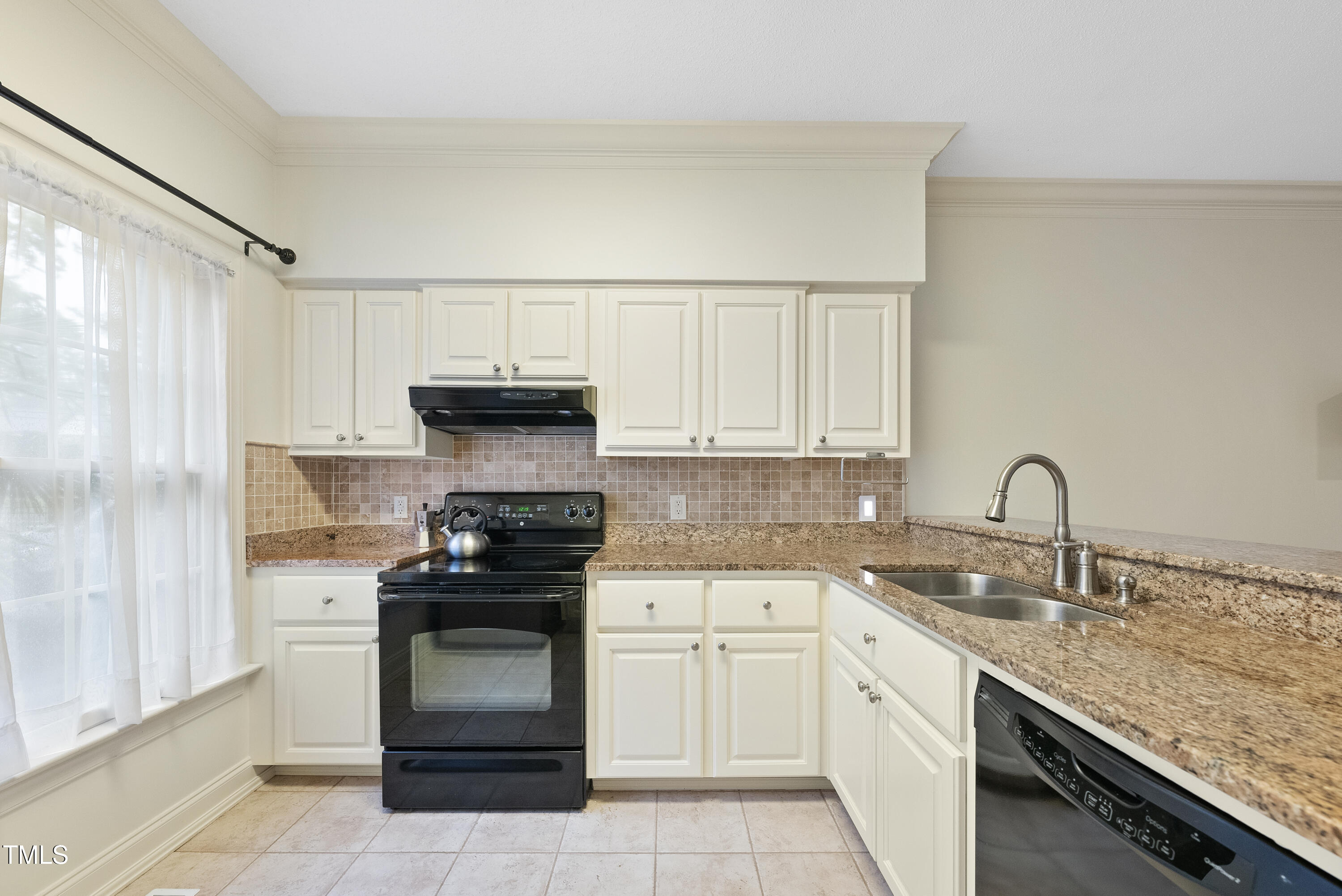 1403 Governors Court Raleigh, NC 27604 - Photo 5 of 34 a kitchen with granite countertop white cabinets and stainless steel appliances