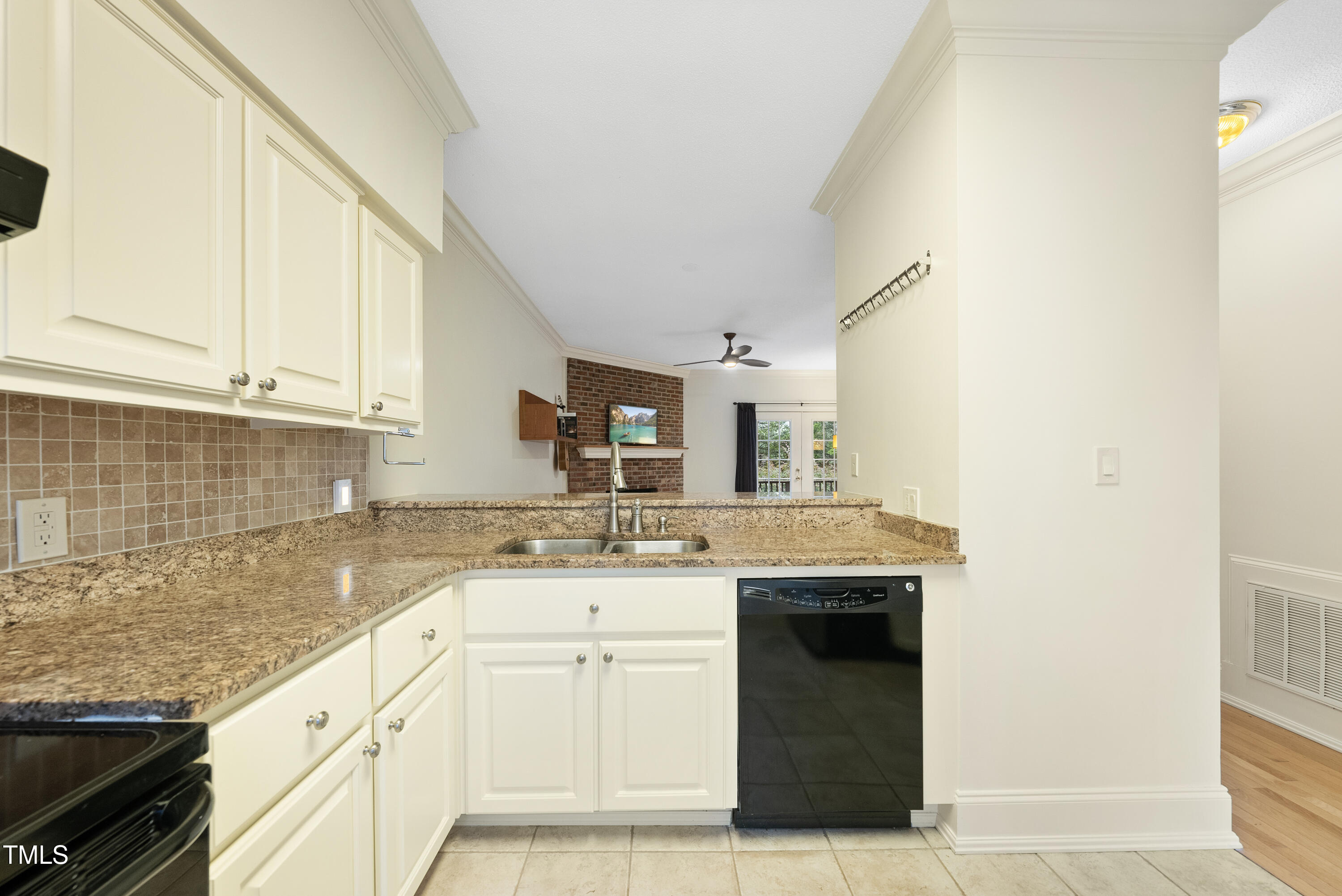 1403 Governors Court Raleigh, NC 27604 - Photo 6 of 34 a kitchen with granite countertop a sink stainless steel appliances and cabinets