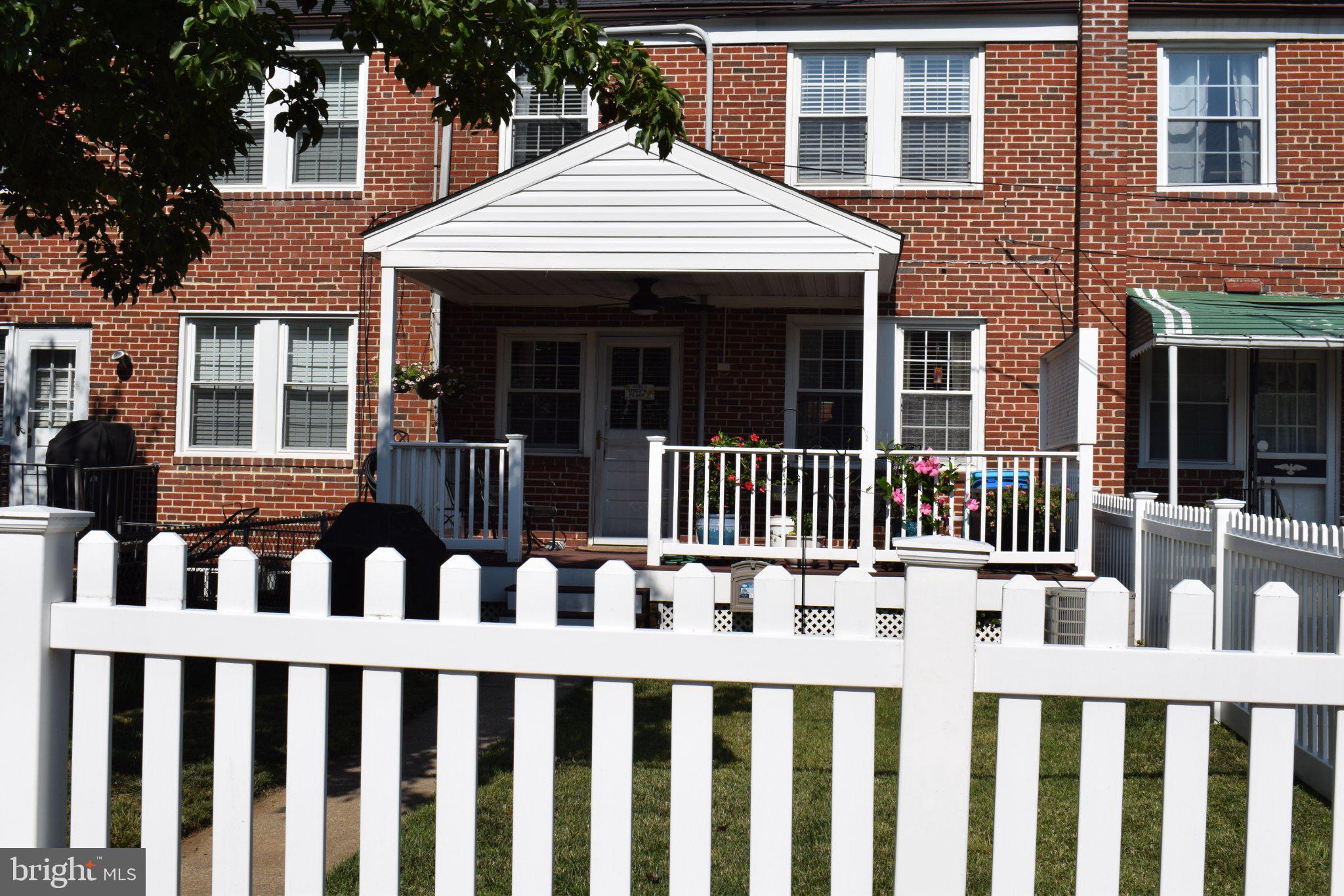 310 Whitfield Road Baltimore, MD 21228 - Photo 2 of 2 Charming brick home with white fence.
