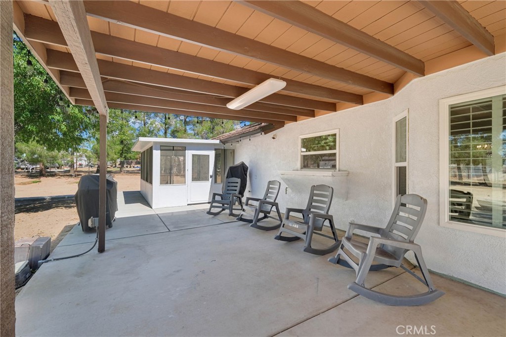15908 Acoma Road Apple Valley, CA 92307 - Photo 47 of 62 Sunroom has its own separate exit leading into covered backyard patio hooked up with electric, and ready for entertaining your guests.
