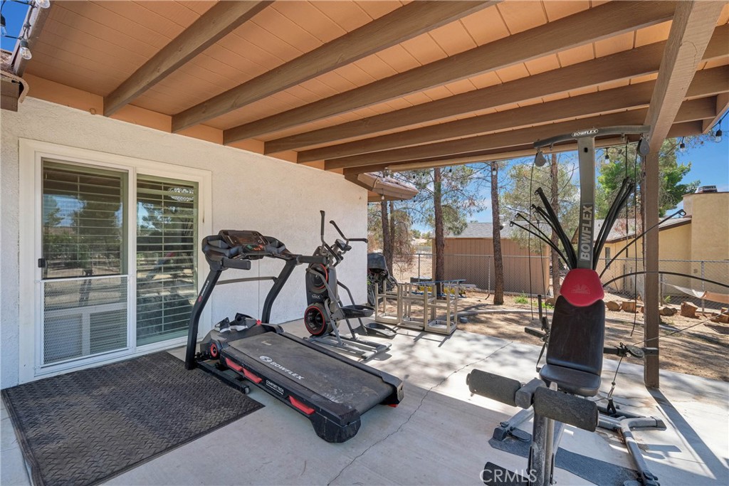 15908 Acoma Road Apple Valley, CA 92307 - Photo 48 of 62 Backyard covered patio is fully cemented and access to living area, primary bedroom and sunroom.
