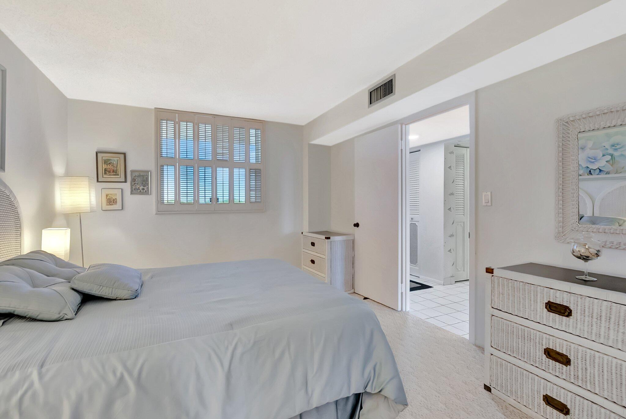 6699 Northwest 2nd Avenue, Unit 410 Boca Raton, FL 33487 - Photo 19 of 29 a bedroom with a bed and a dresser