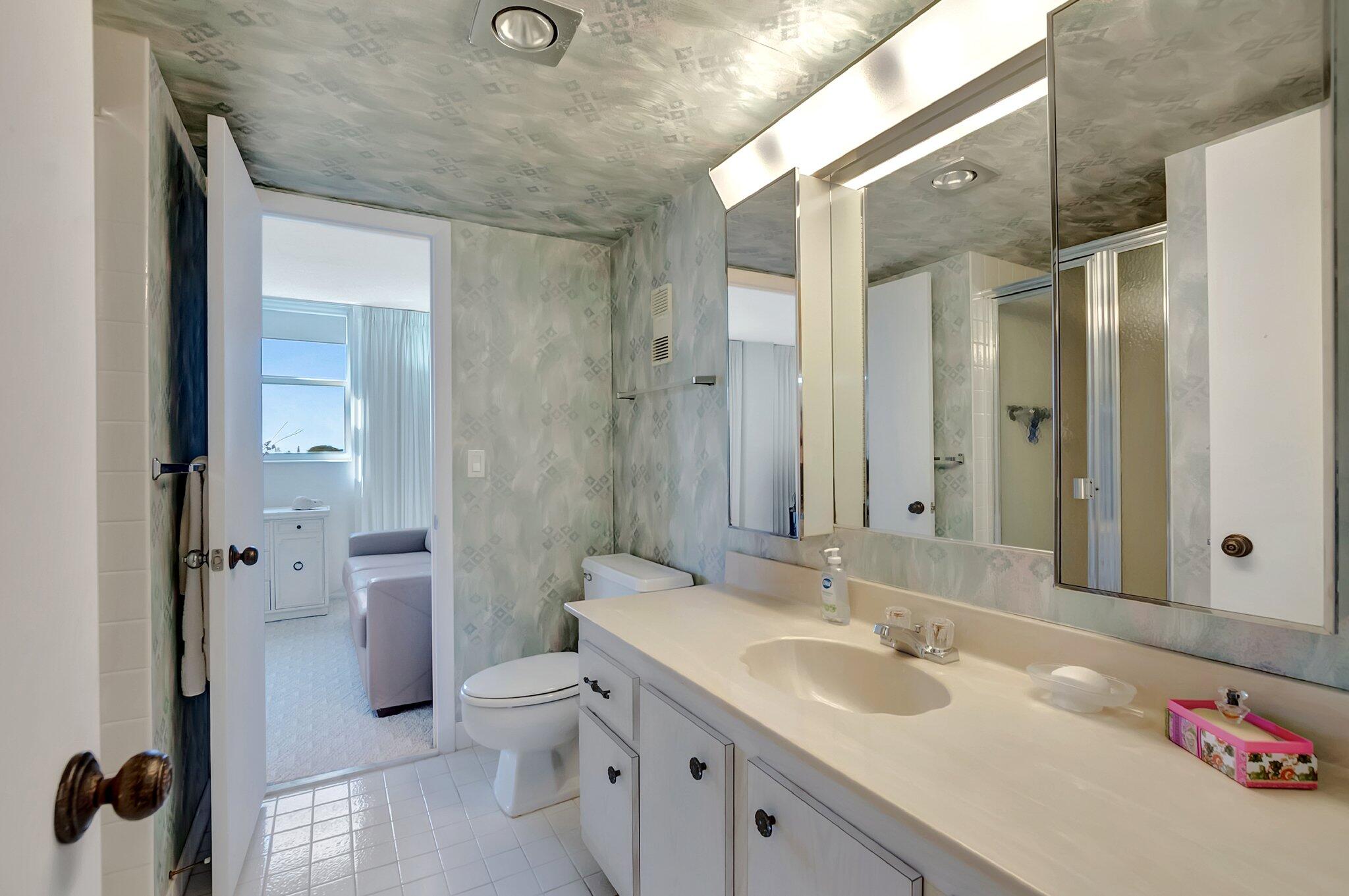 6699 Northwest 2nd Avenue, Unit 410 Boca Raton, FL 33487 - Photo 20 of 29 a bathroom with a sink a toilet and shower