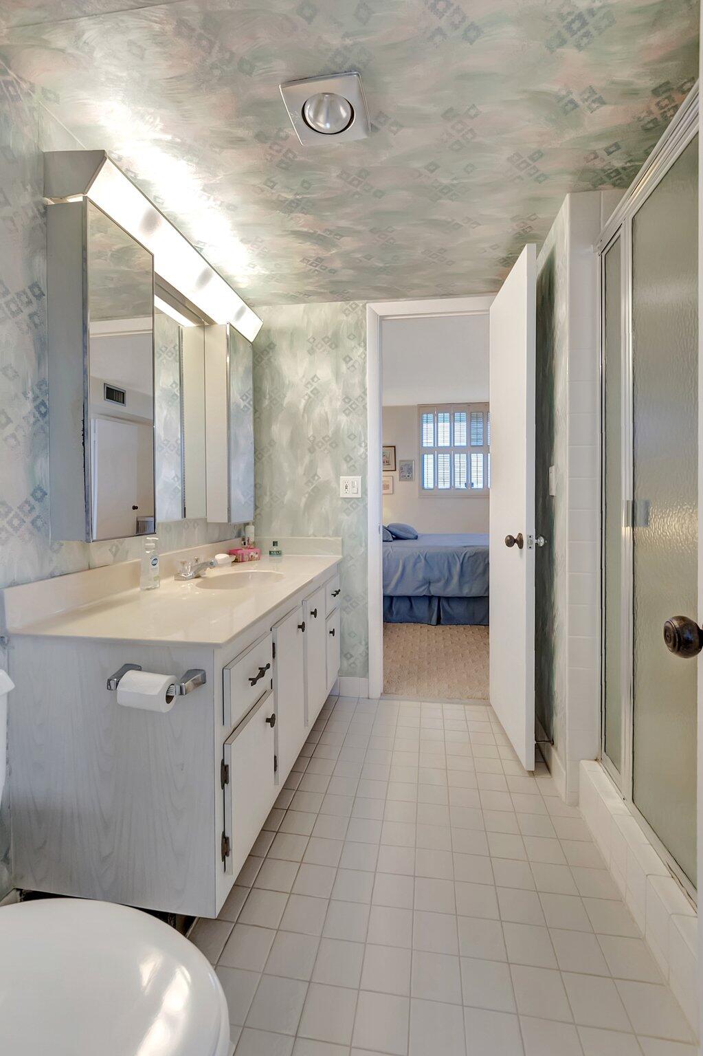 6699 Northwest 2nd Avenue, Unit 410 Boca Raton, FL 33487 - Photo 21 of 29 a bathroom with a double vanity sink and mirror