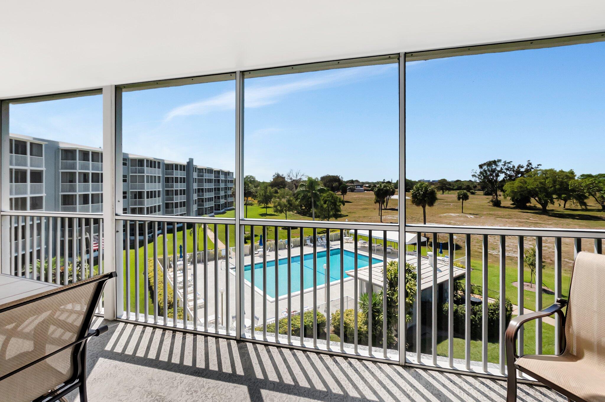 6699 Northwest 2nd Avenue, Unit 410 Boca Raton, FL 33487 - Photo 22 of 29 a view of a balcony with floor to ceiling window next to a palm tree
