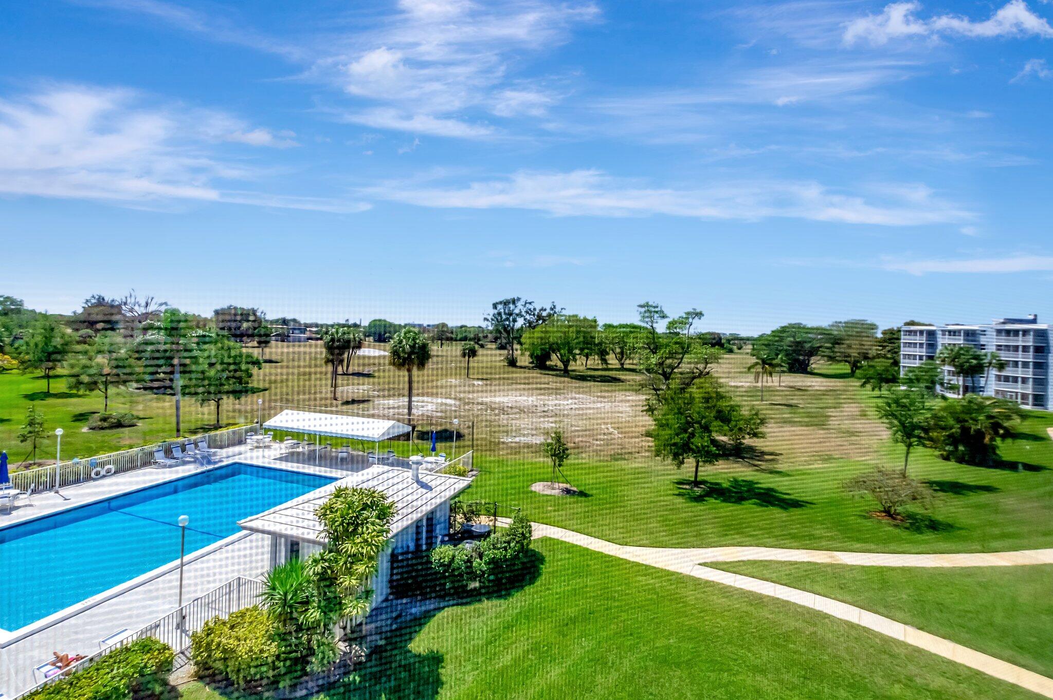 6699 Northwest 2nd Avenue, Unit 410 Boca Raton, FL 33487 - Photo 25 of 29 a view of a lake with a yard