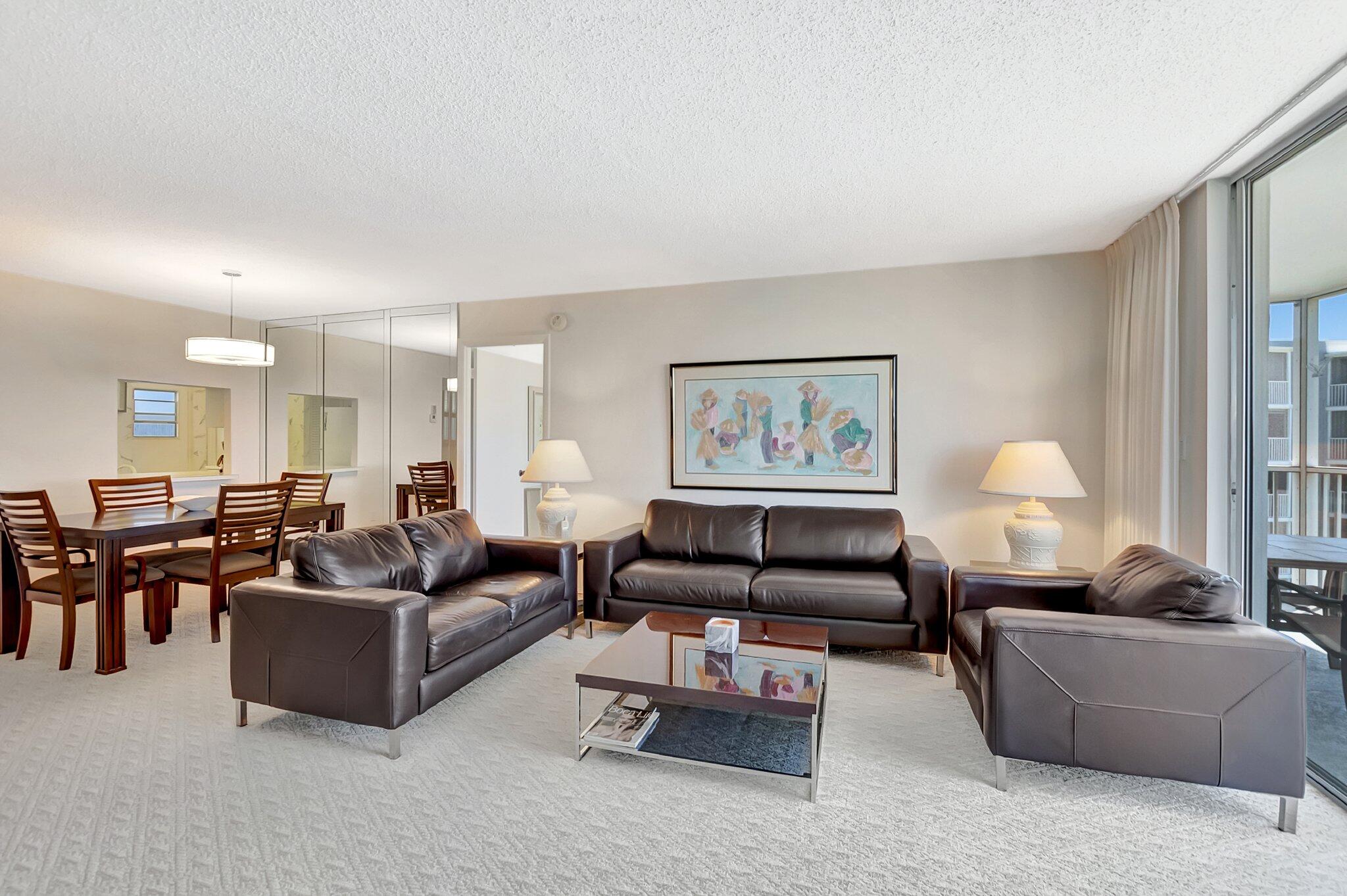 6699 Northwest 2nd Avenue, Unit 410 Boca Raton, FL 33487 - Photo 3 of 29 a living room with furniture and a lamp