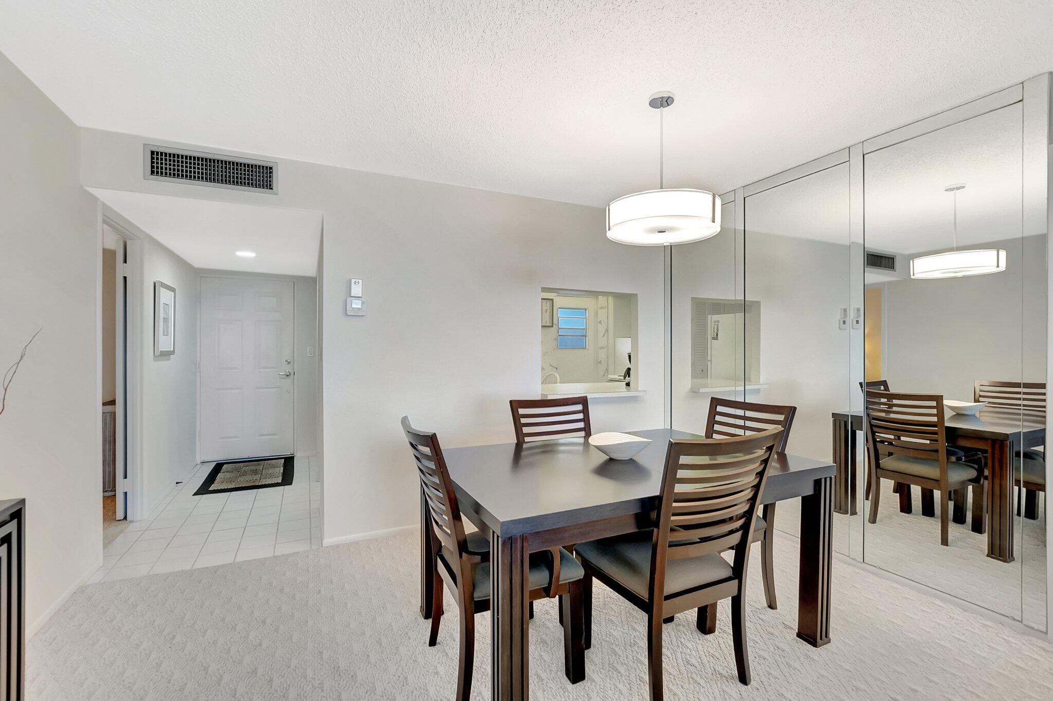 6699 Northwest 2nd Avenue, Unit 410 Boca Raton, FL 33487 - Photo 6 of 29 a view of a dining room with furniture