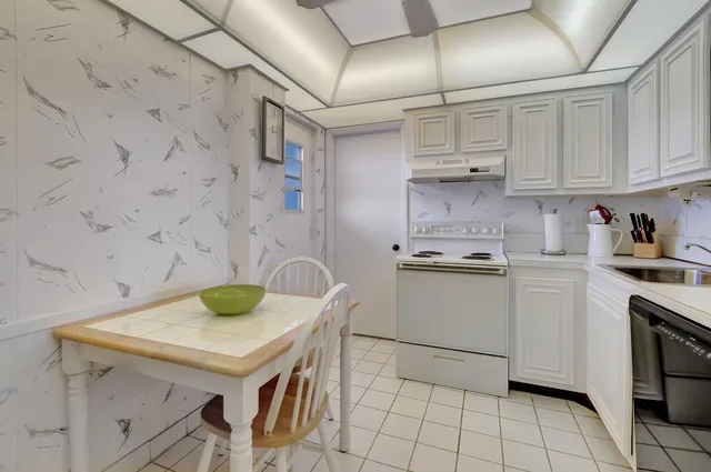 a kitchen with a sink a stove and cabinets
