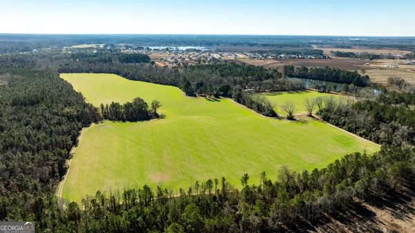 an aerial view of residential houses with outdoor space and swimming pool
