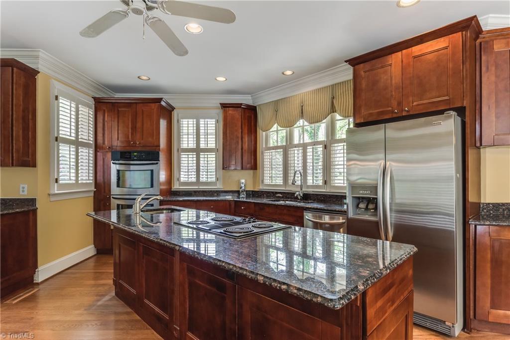 3605 Gaston Road Greensboro, NC 27407 - Photo 11 of 30 SS appliances, large island, 2 sinks, granite countertops and much more in this grand Kitchen.