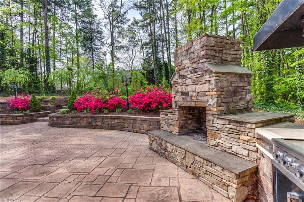 3605 Gaston Road Greensboro, NC 27407 - Photo 23 of 30 Outdoor fireplace & grill within this gorgeous backyard oasis.