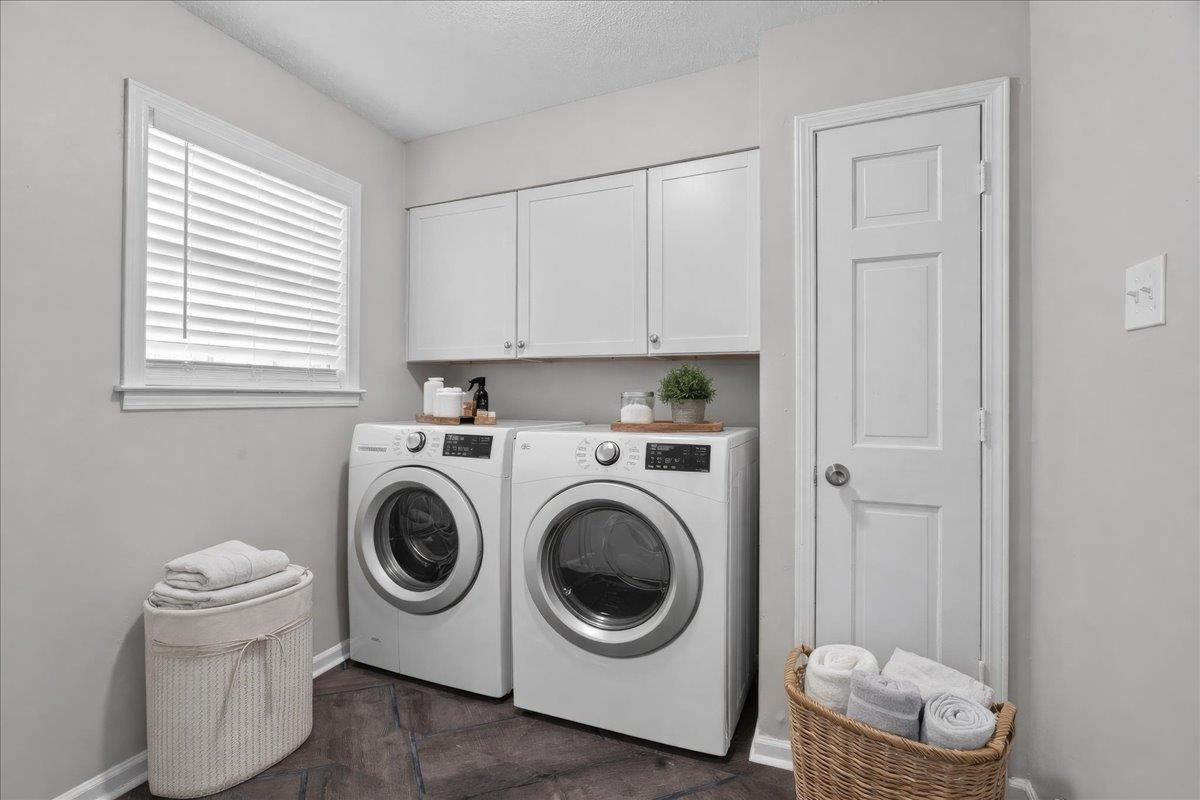 6010 Fox Ridge Drive Memphis, TN 38115 - Photo 19 of 34 Laundry area with cabinet space and washer and clothes dryer