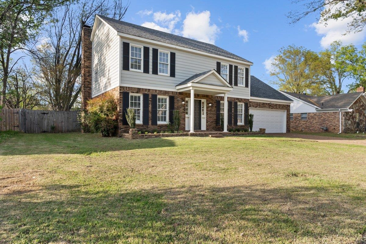 6010 Fox Ridge Drive Memphis, TN 38115 - Photo 2 of 34 View of front of property featuring brick siding, an attached garage, roof with shingles, and driveway