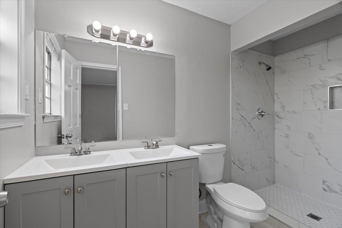 6010 Fox Ridge Drive Memphis, TN 38115 - Photo 21 of 34 Full bathroom with double vanity and tiled shower