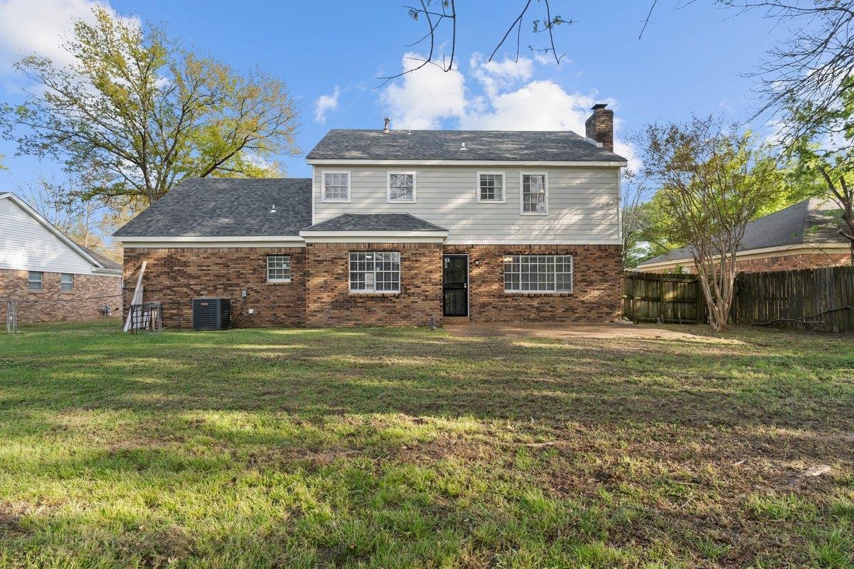 6010 Fox Ridge Drive Memphis, TN 38115 - Photo 30 of 34 Back of house with brick siding and a chimney