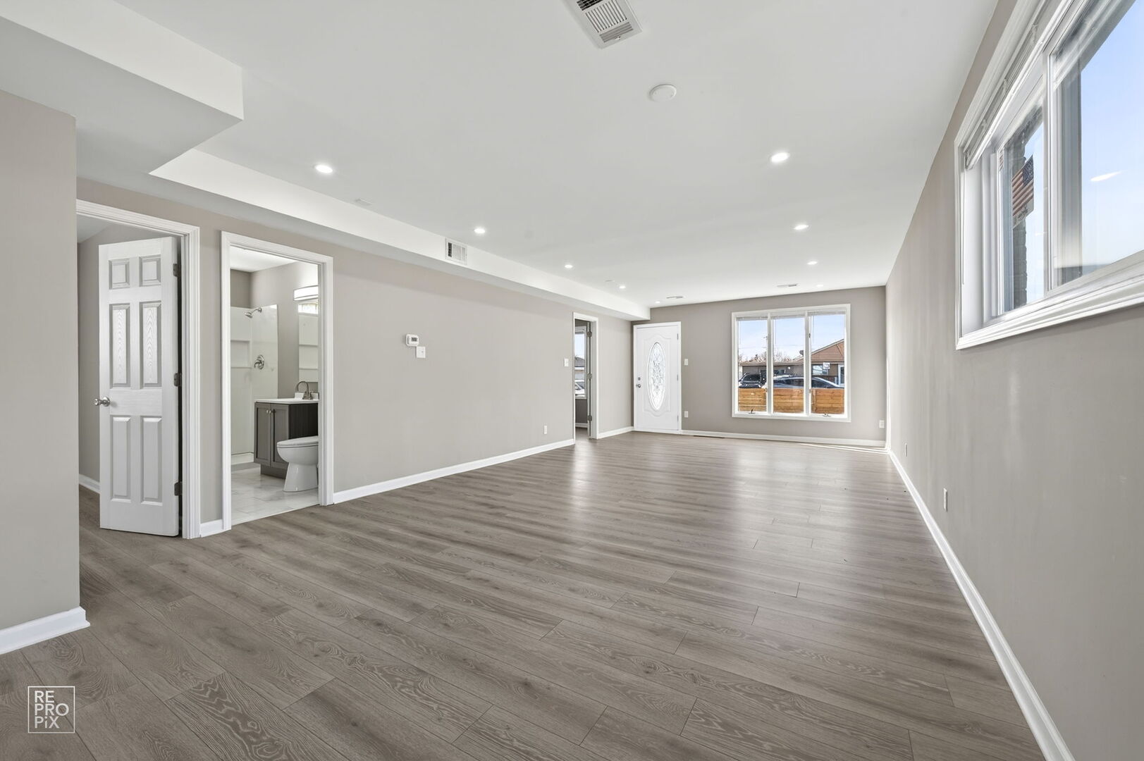 4680 West 83rd Street Chicago, IL 60652 - Photo 4 of 22 a view of an empty room with wooden floor and a window