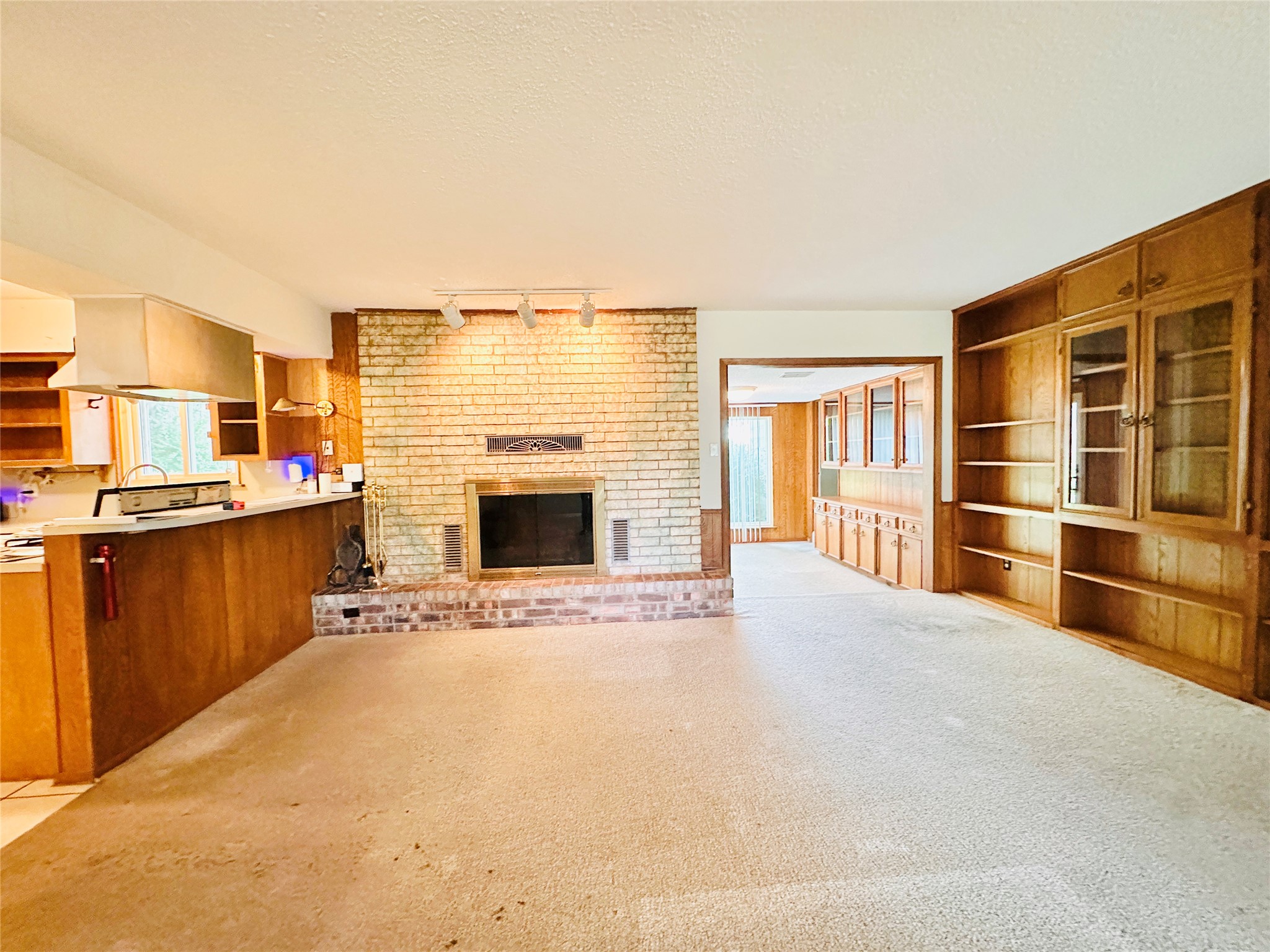 1704 Parkside Lane Austin, TX 78745 - Photo 37 of 39 Oversized living/dining area with wood burning fireplace, wall of custom built-ins, and open floorplan