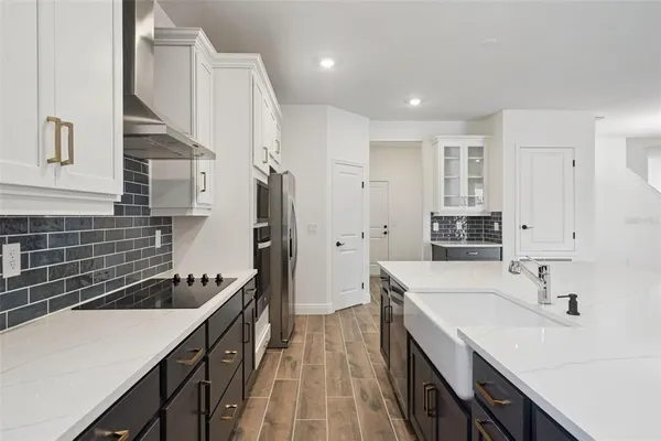 a kitchen with a sink stove and refrigerator
