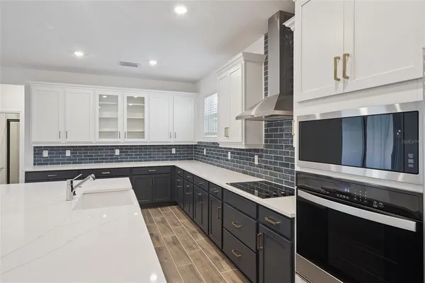 a kitchen with a sink stove and cabinets