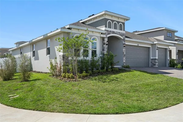 a front view of a house with a yard