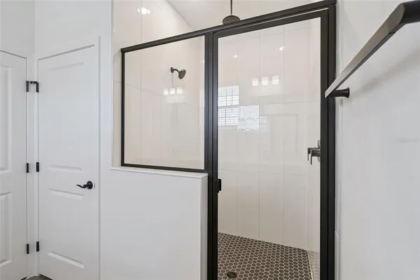 a bathroom with a glass shower door